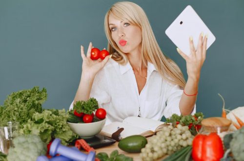 Vlogger promoting healthy eating with fresh vegetables on the table.