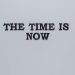 Minimalist poster with the motivational quote 'The Time is Now' on a gray background.